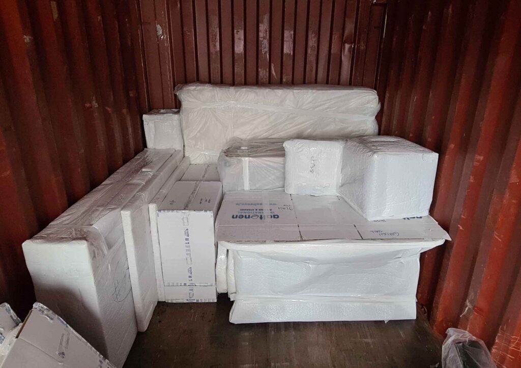 Wrapped furniture and cartons loaded inside a shipping container